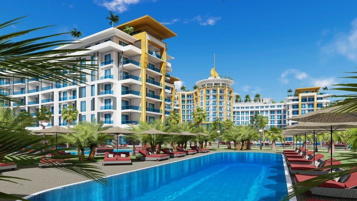 Two-room apartment for sale in Türkler Alanya – exterior view of the residential complex with sea in the background